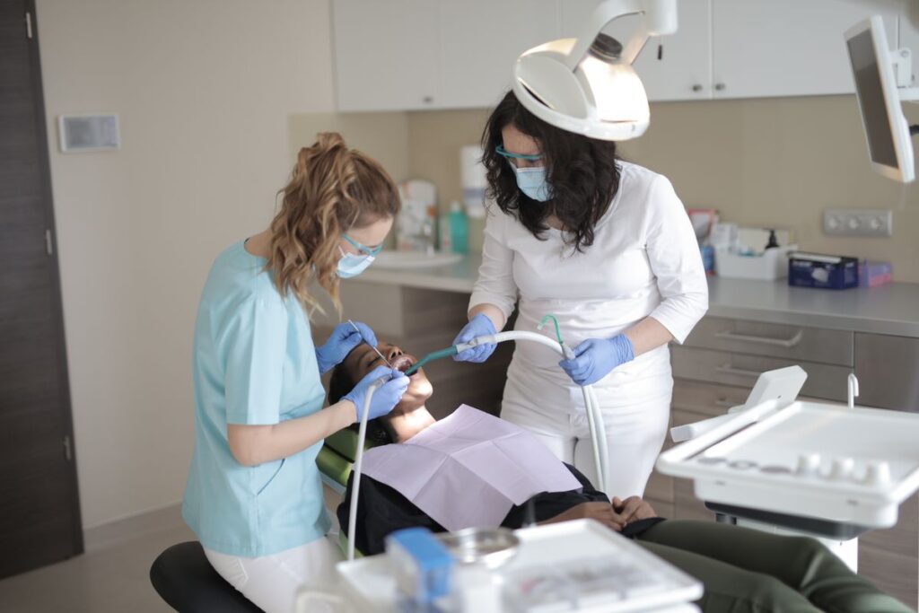 Dental hygienist cleaning a patient's teeth at a Birmingham dental clinic